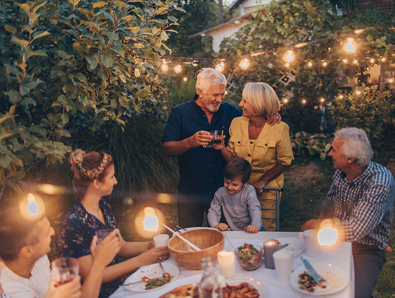 multi-generational family having dinner outside