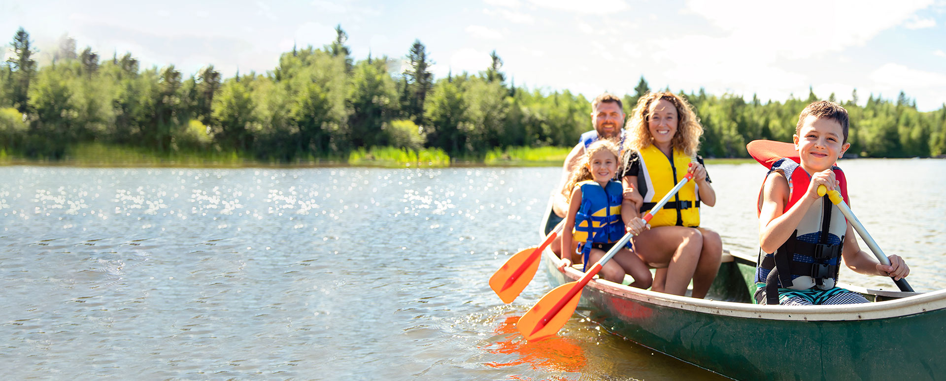 family in canoe having fun