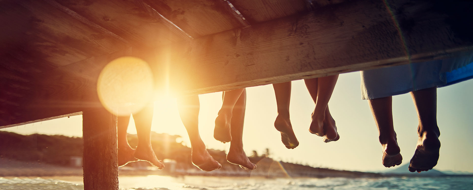 children's feet hanging down off dock