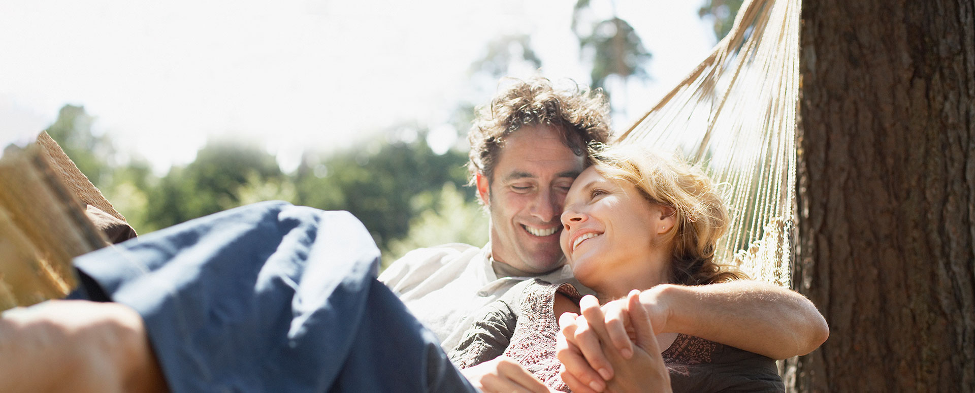 young couple cuddling in hammock